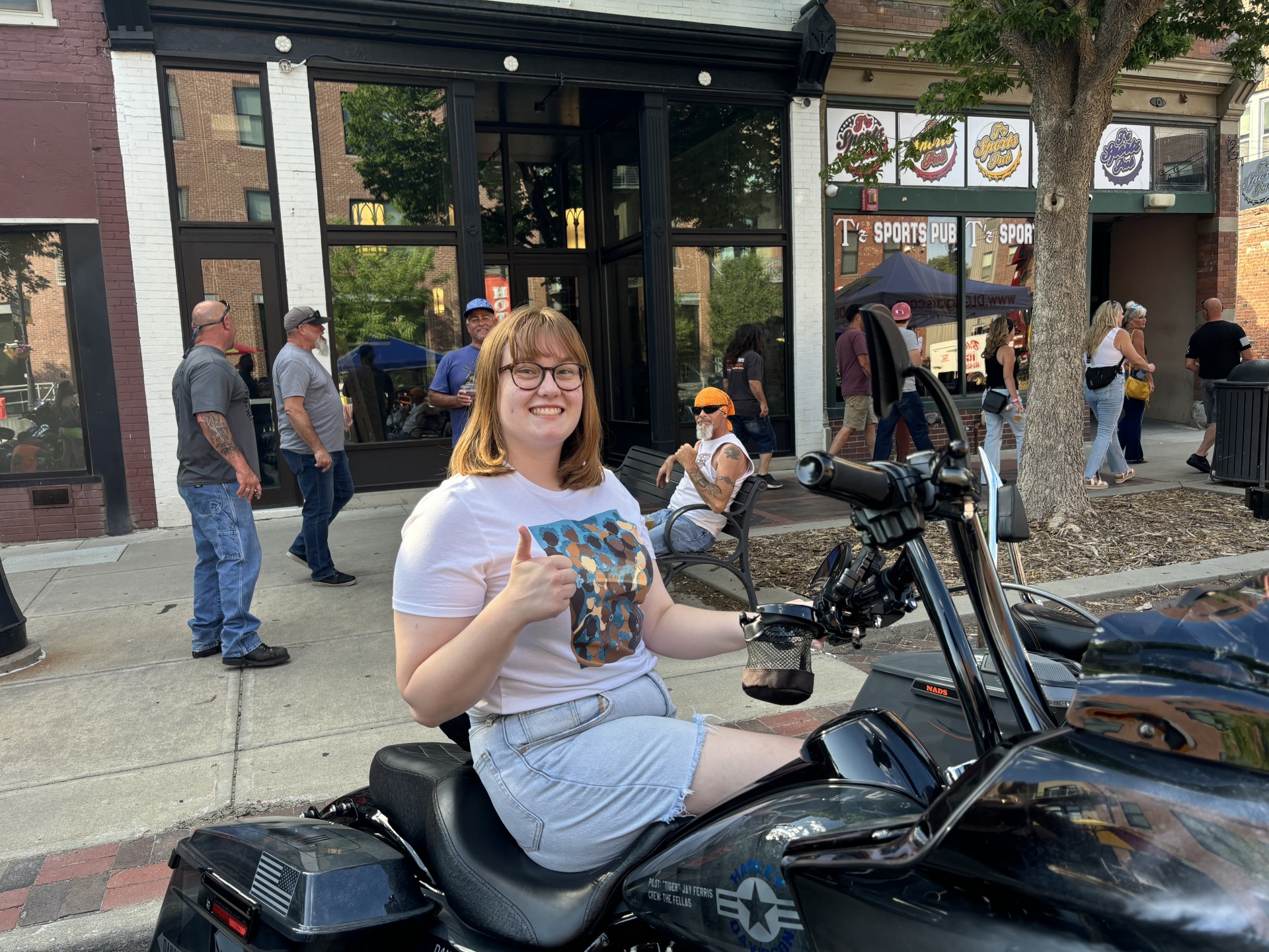 Emily Newby sits on a motorcycle during Bikes on the Hundred Block event