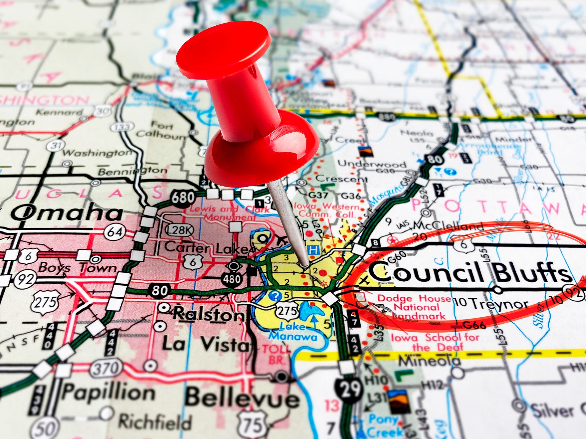 A pin and circle on a map show proximity between Omaha and Council Bluffs