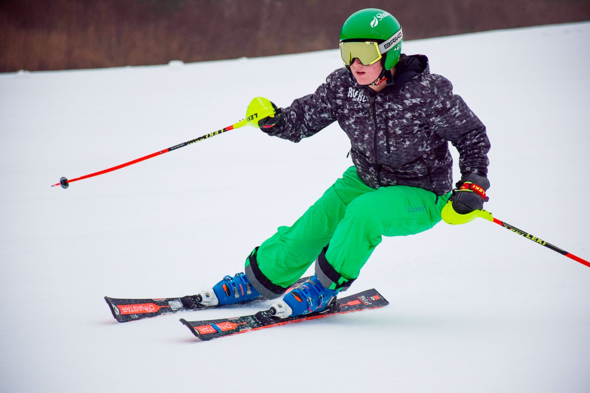 a visitor skis slopes with goggles at Crescent Hill
