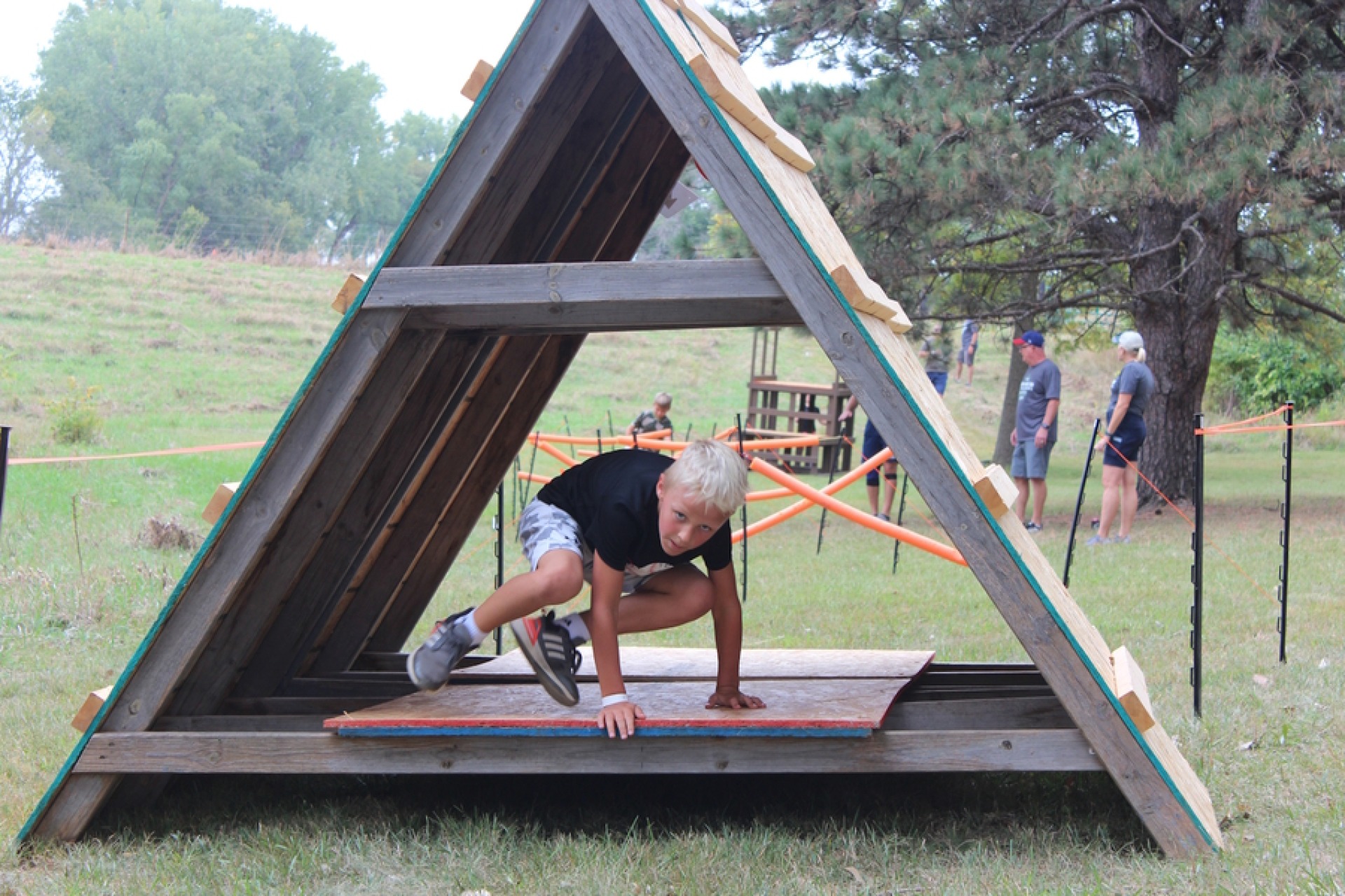 A child leaps through an obstacle course 