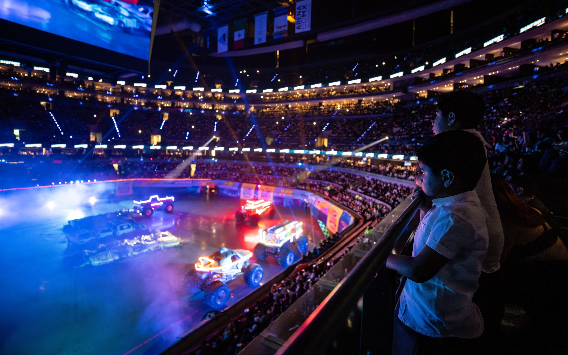 Kid enjoying the hot wheels monster truck show from above