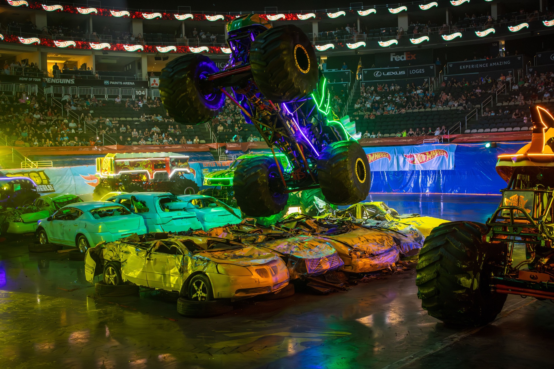 Monster truck soaring over other cars at Hot Wheels Sow