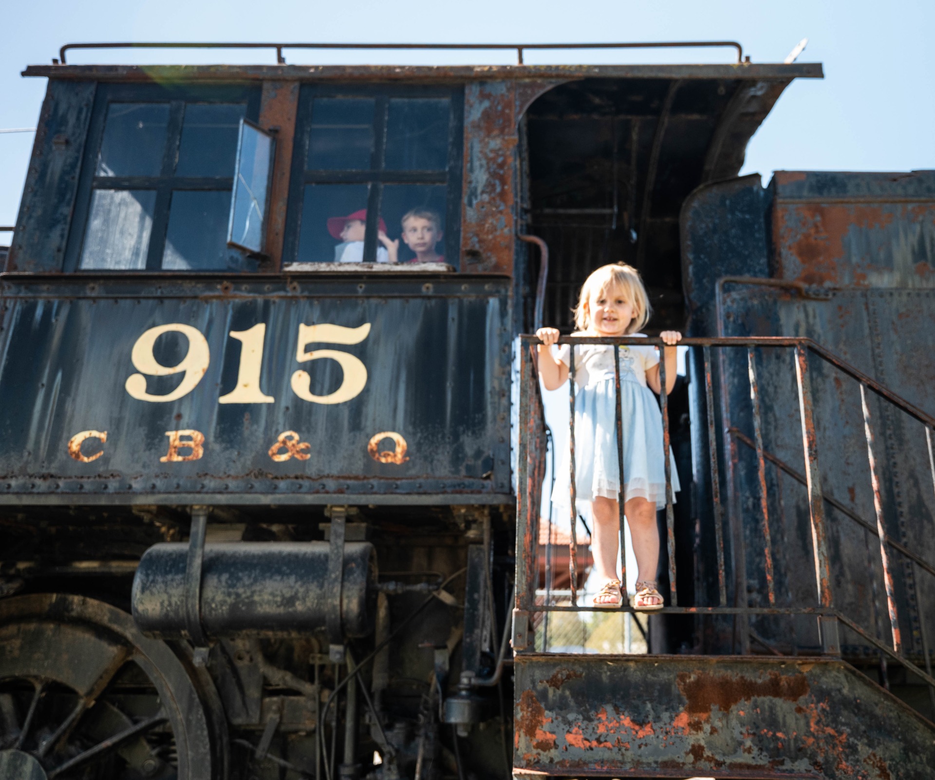 Children explore an old locomotive at RailsWest Railroad Museum