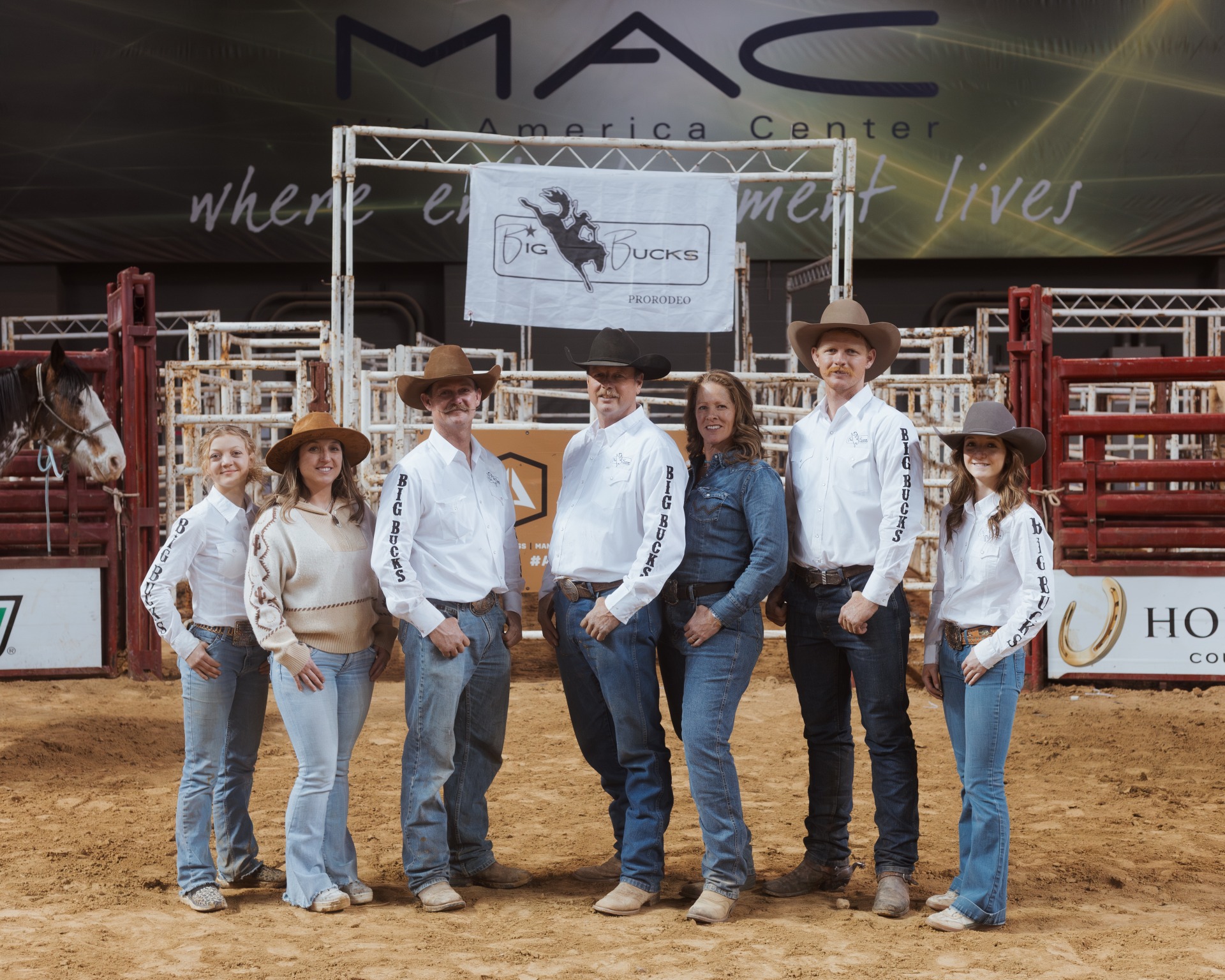 A Group of people standing at the rodeo