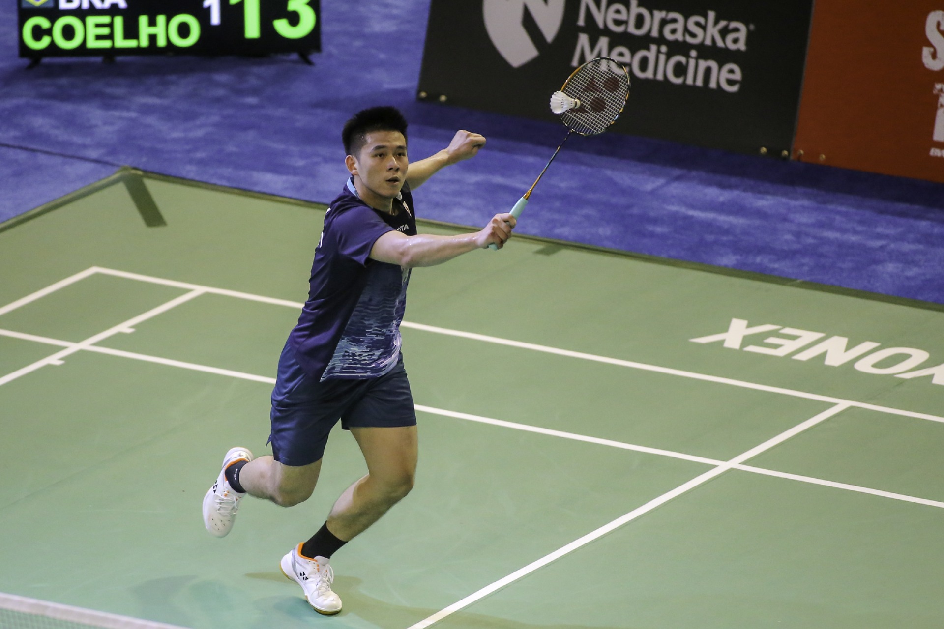 a badminton player swings at the 2023 US Open in Council Bluffs