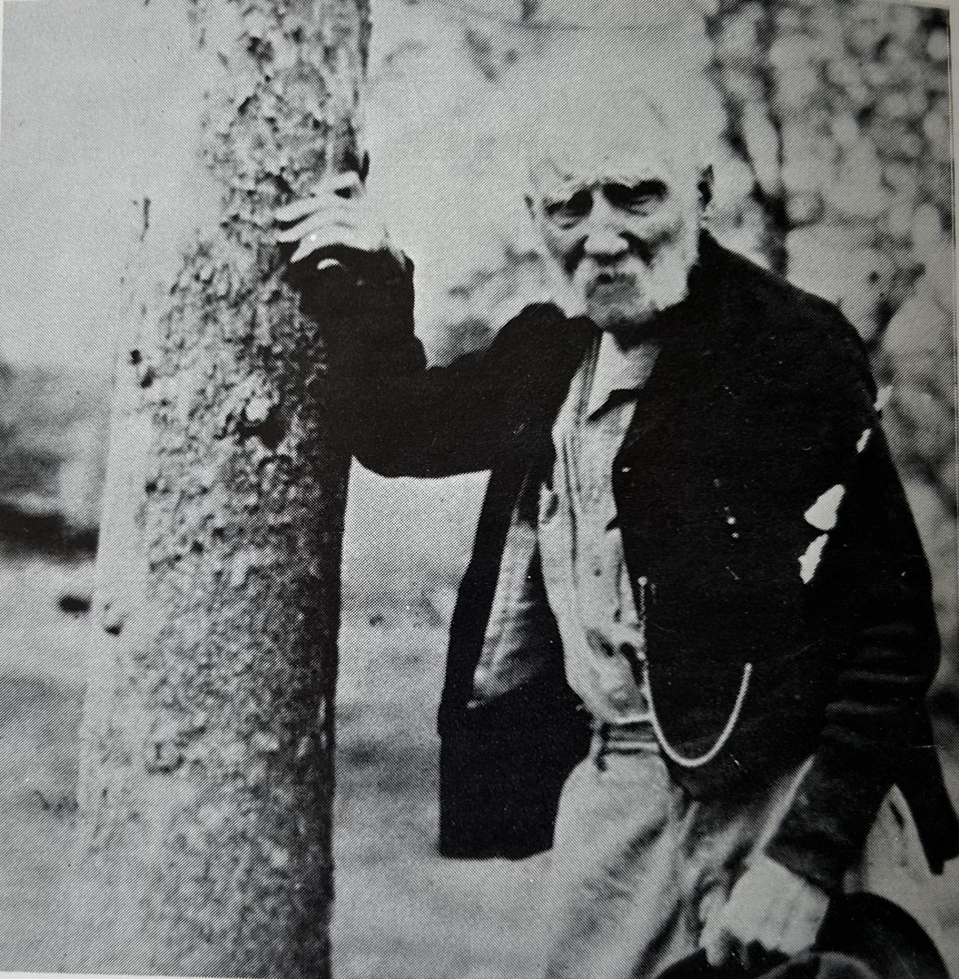 Dr. Barker Jennifer Gerry leaning against a tree.