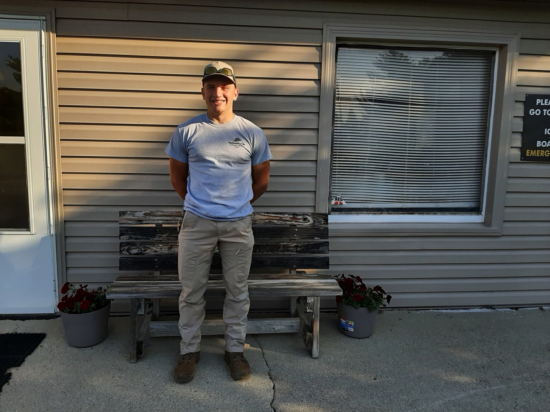 A Park Ranger intern poses outside of the camp office at Arrowhead Park.