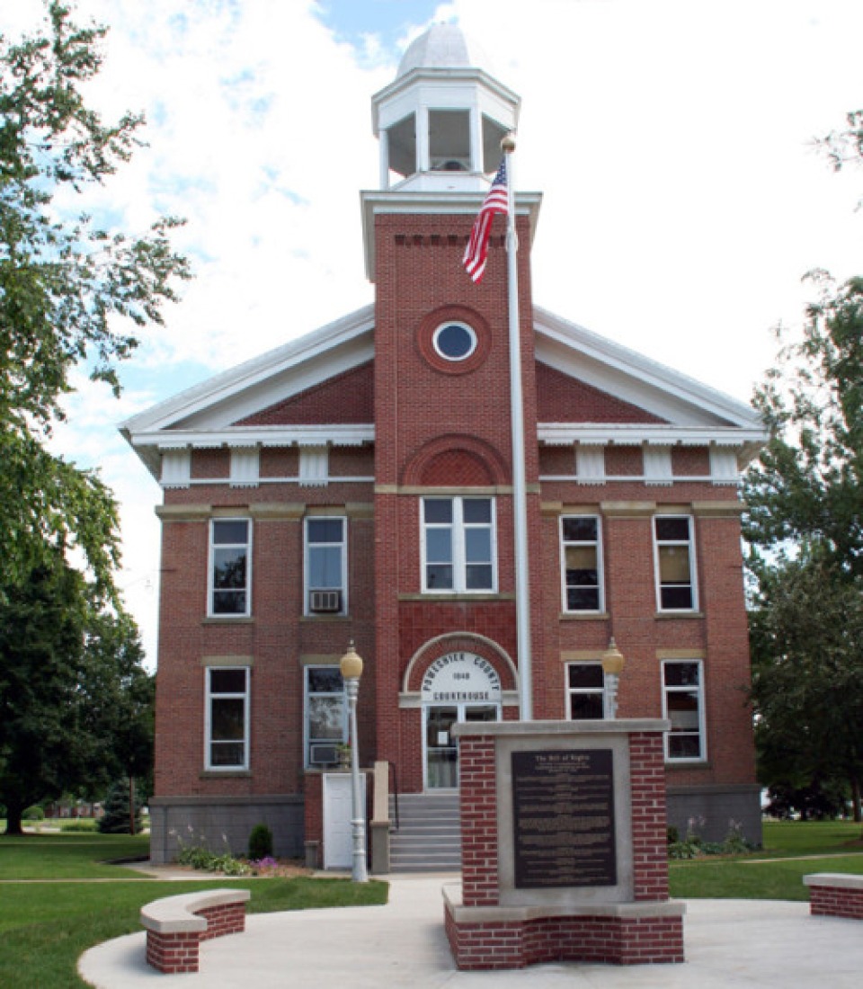 Poweshiek County, Iowa courthouse brick exterior and American flag.